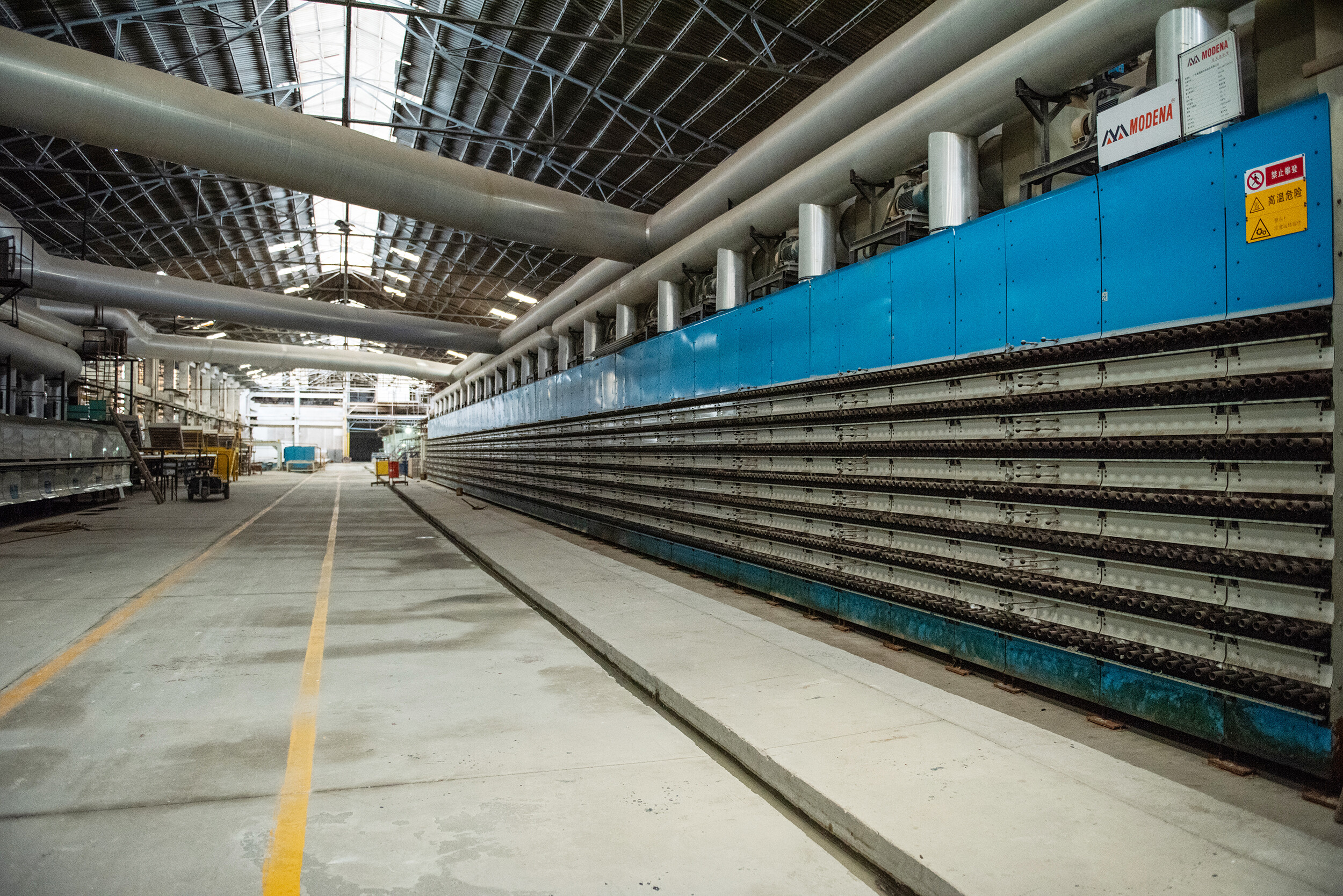 Warehouse with blue-wrapped ceramic wall tile pallets