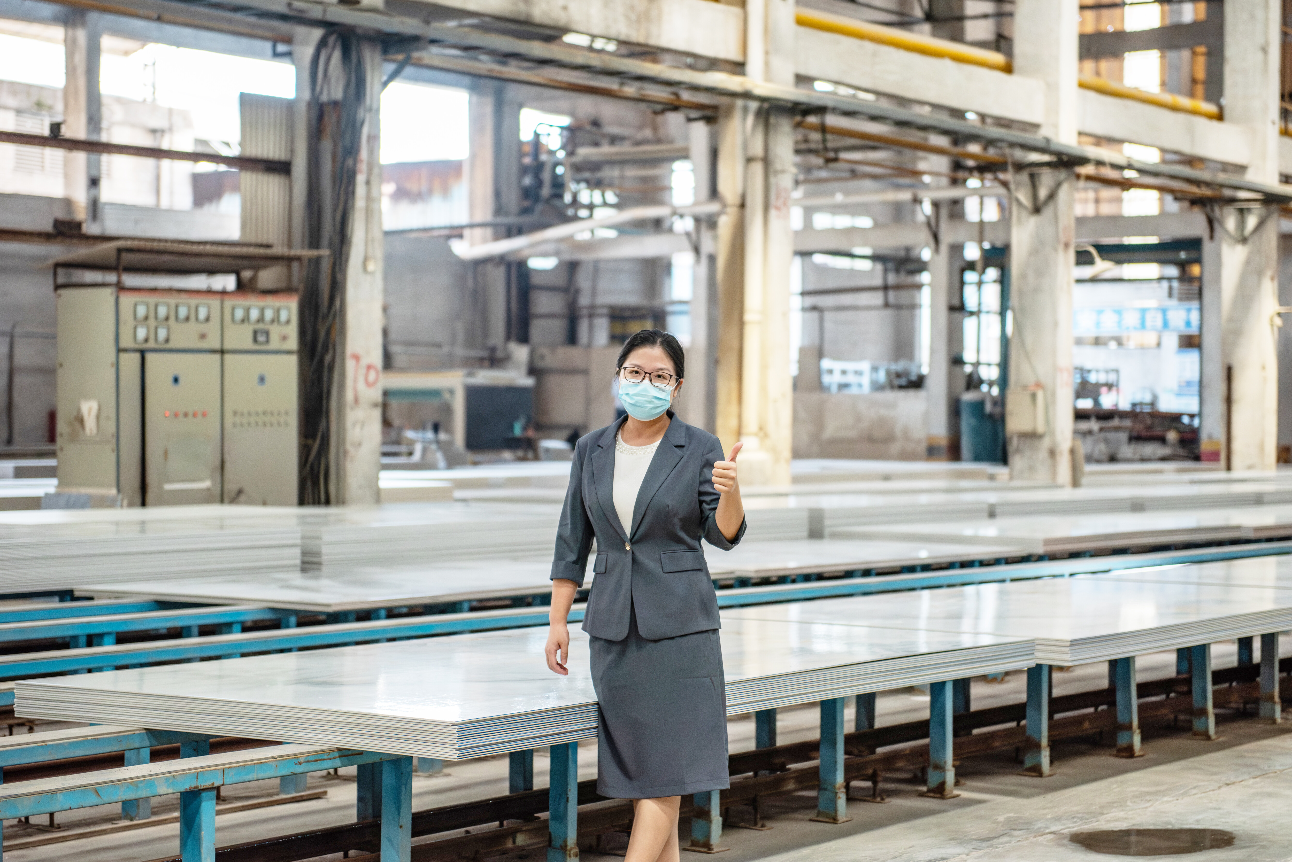 Quality inspector giving thumbs up in factory