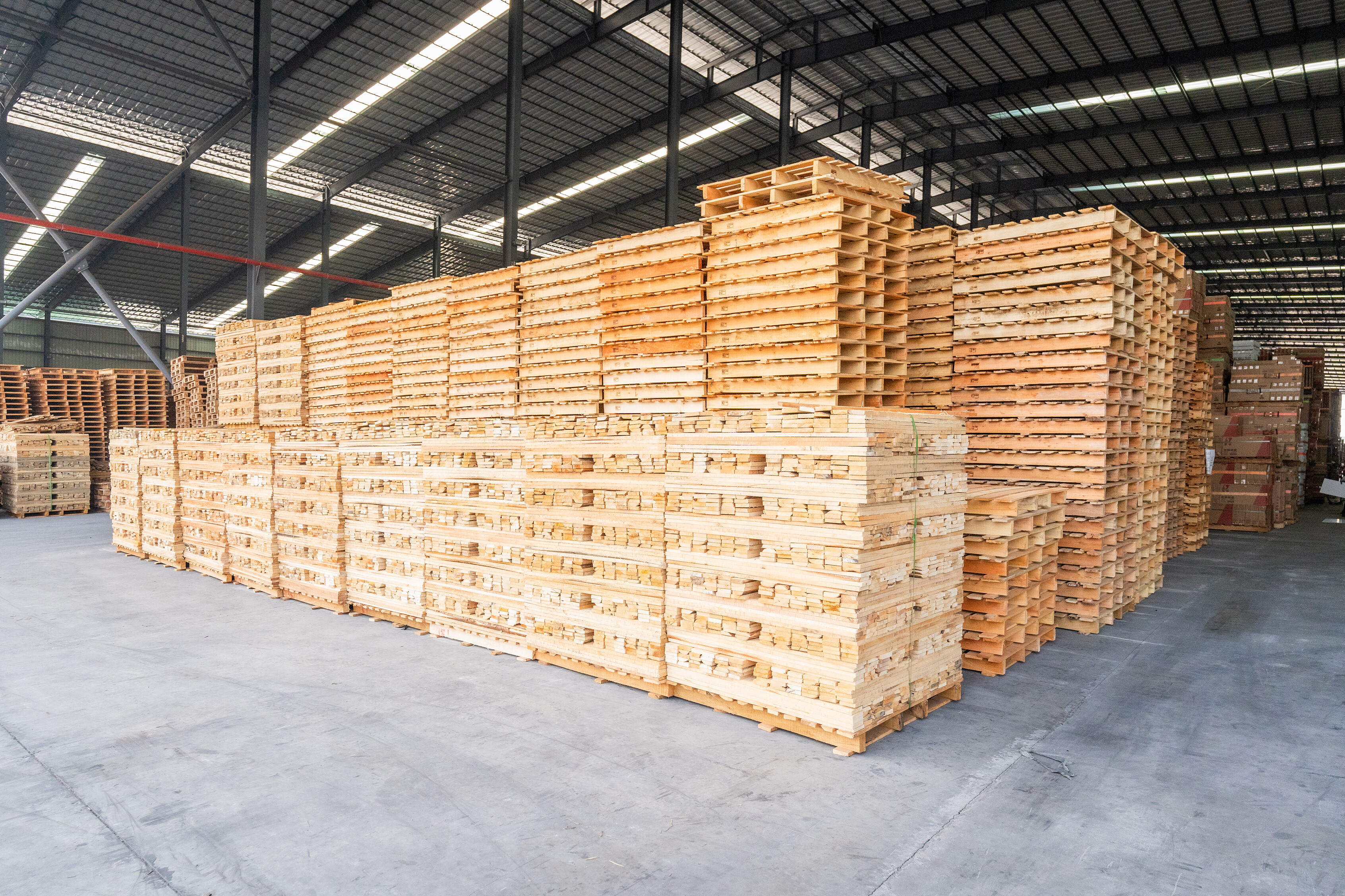 Large warehouse with stacked wooden pallets