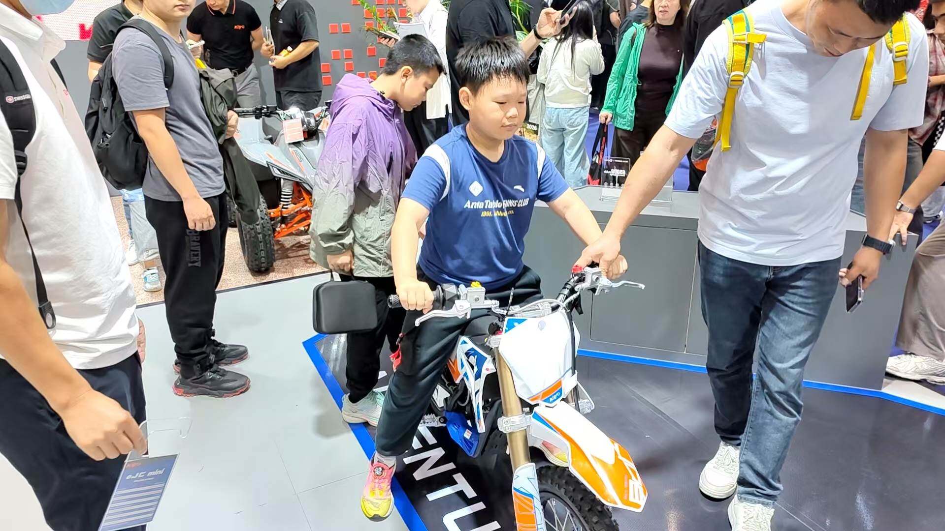 Family audience observes up close at the booth