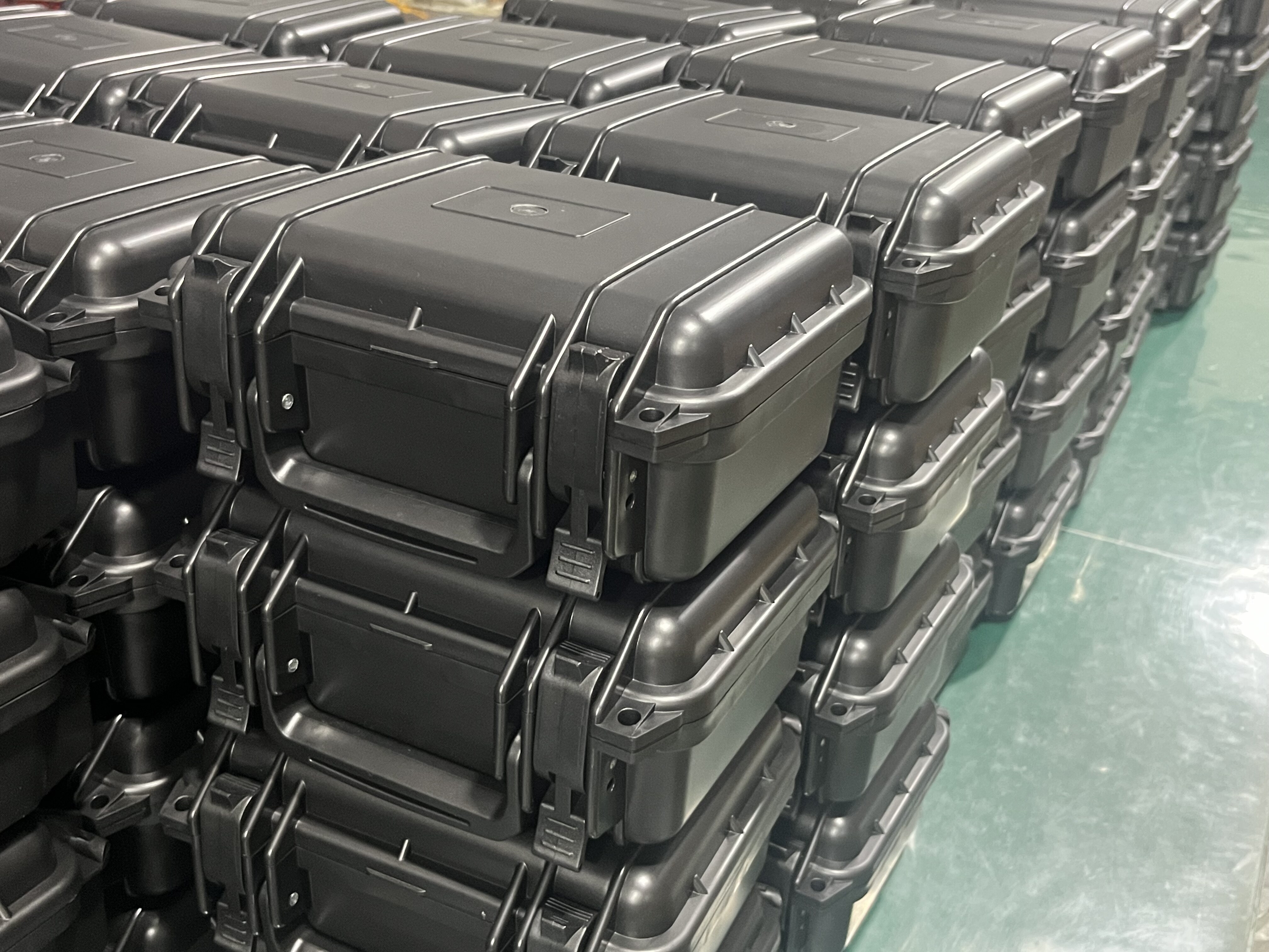 Side view of stacked waterproof cases showing latches and build quality