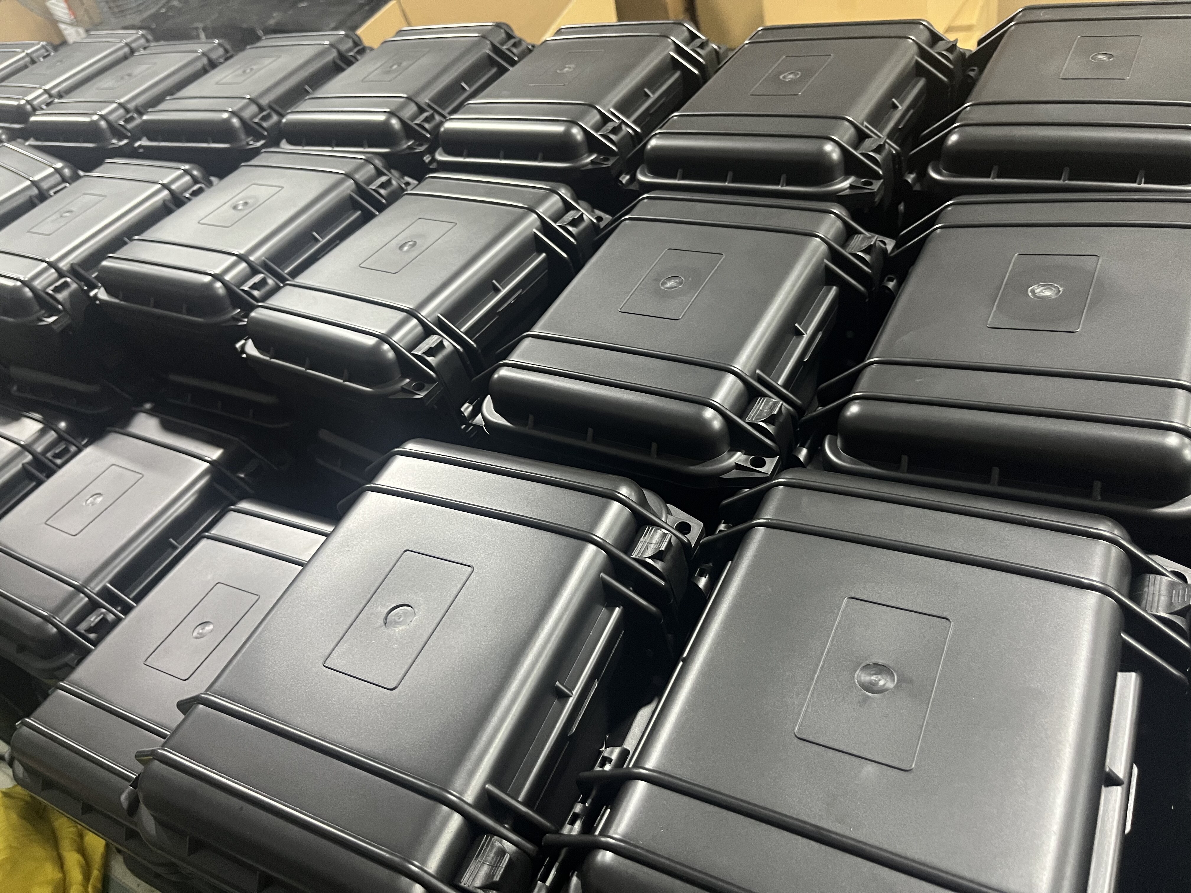 Rows of black waterproof cases arranged neatly