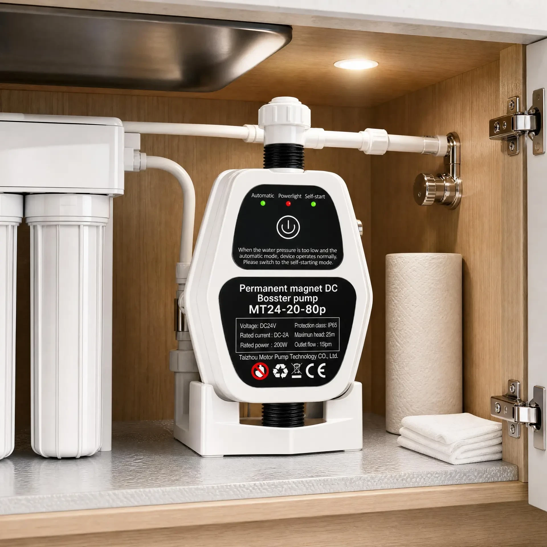 Compact booster pump installed inside a kitchen sink cabinet under the counter