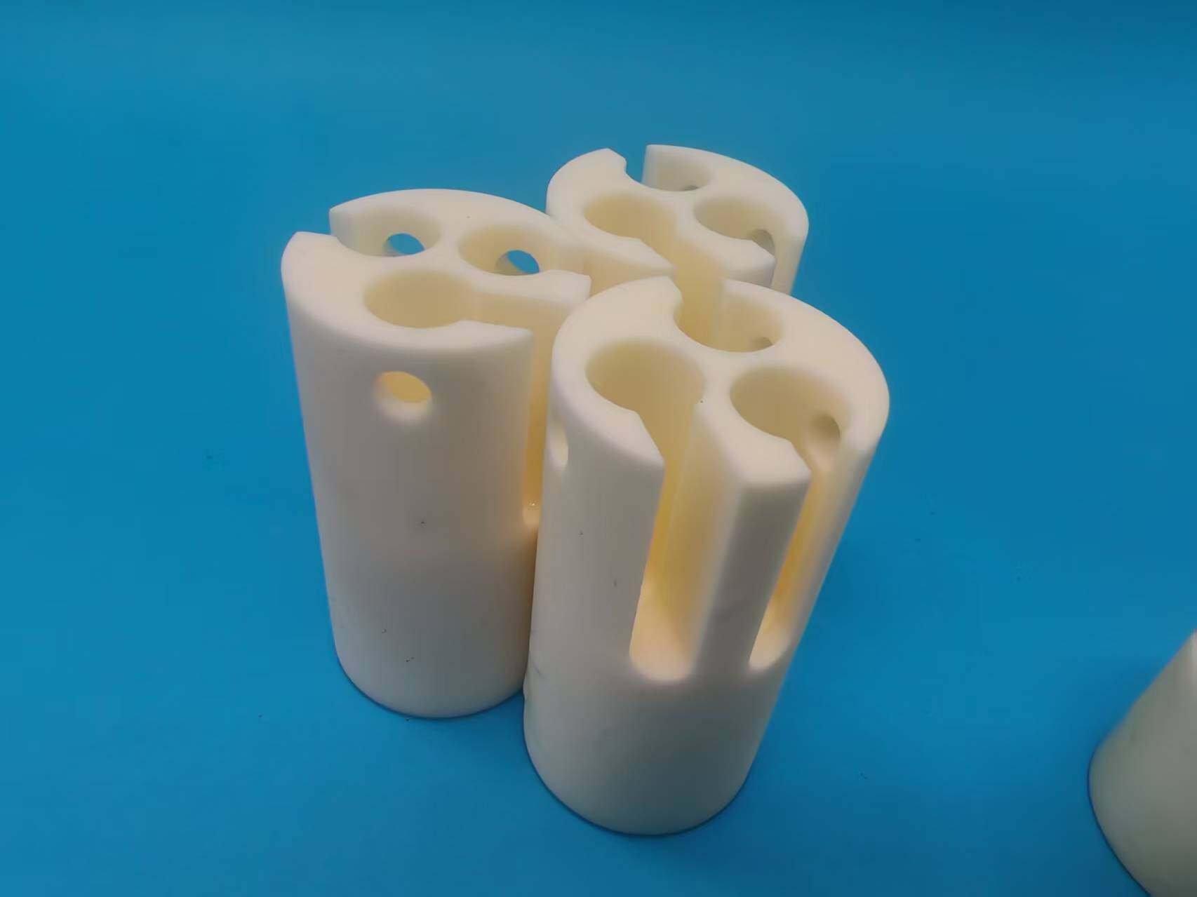 Aluminum nitride ceramic cylindrical components with precision slots