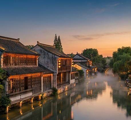 Traditional water-town houses along a misty canal near Shanghai at dawn