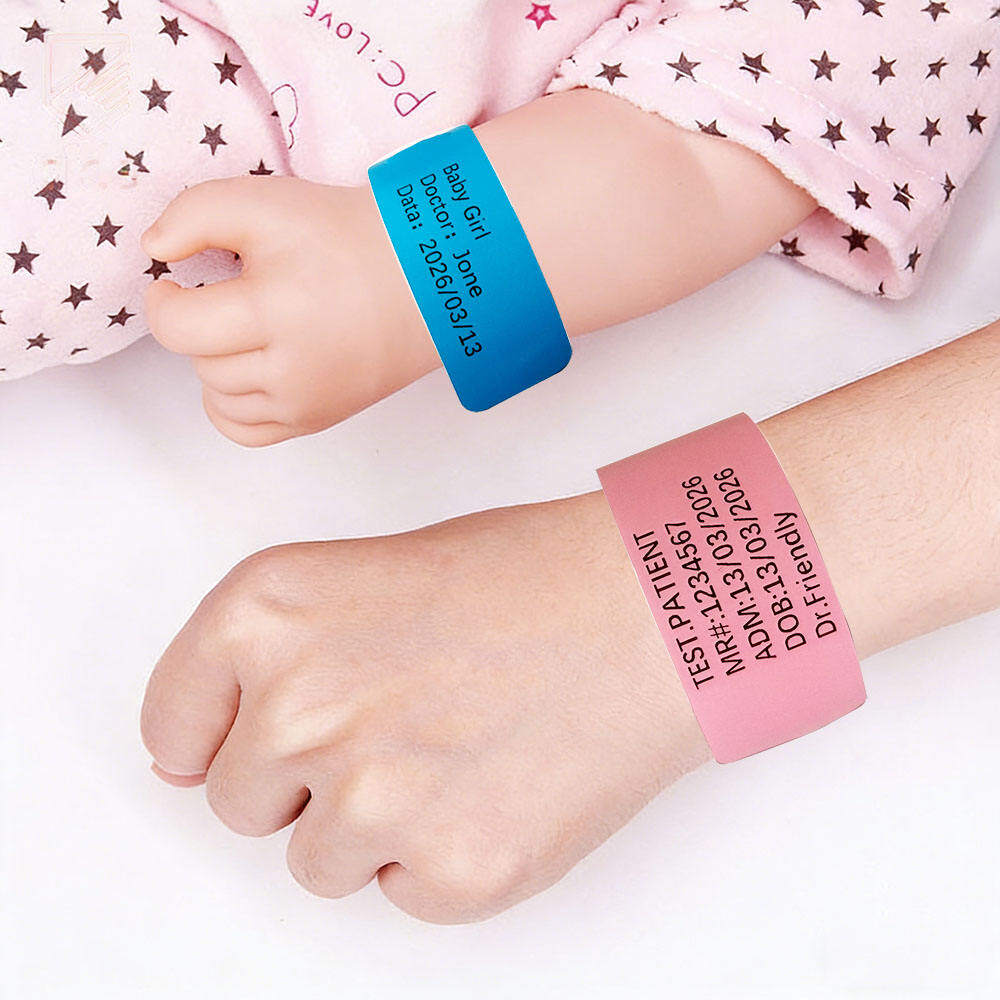 Baby and adult wrists wearing printed blue and pink patient identification wristbands