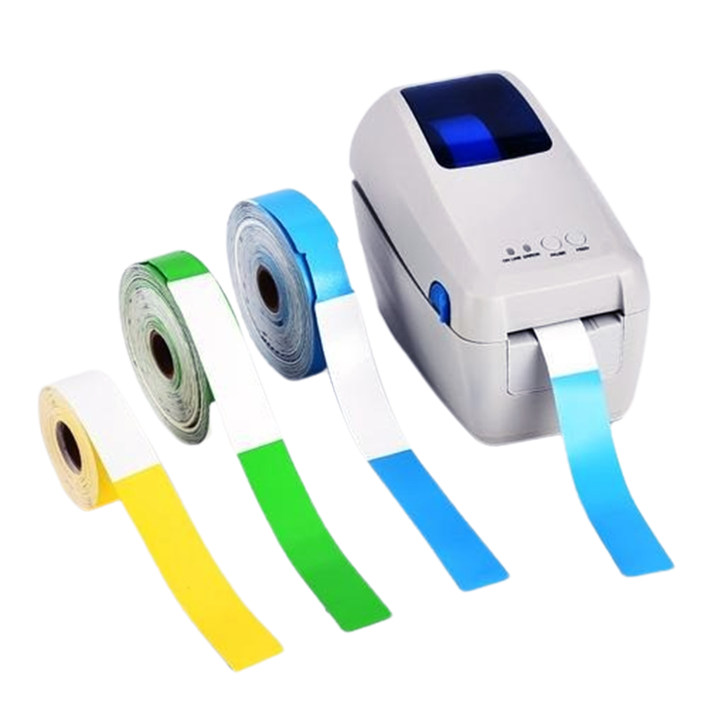 Desktop thermal printer outputting a blue wristband beside yellow, green and blue wristband rolls