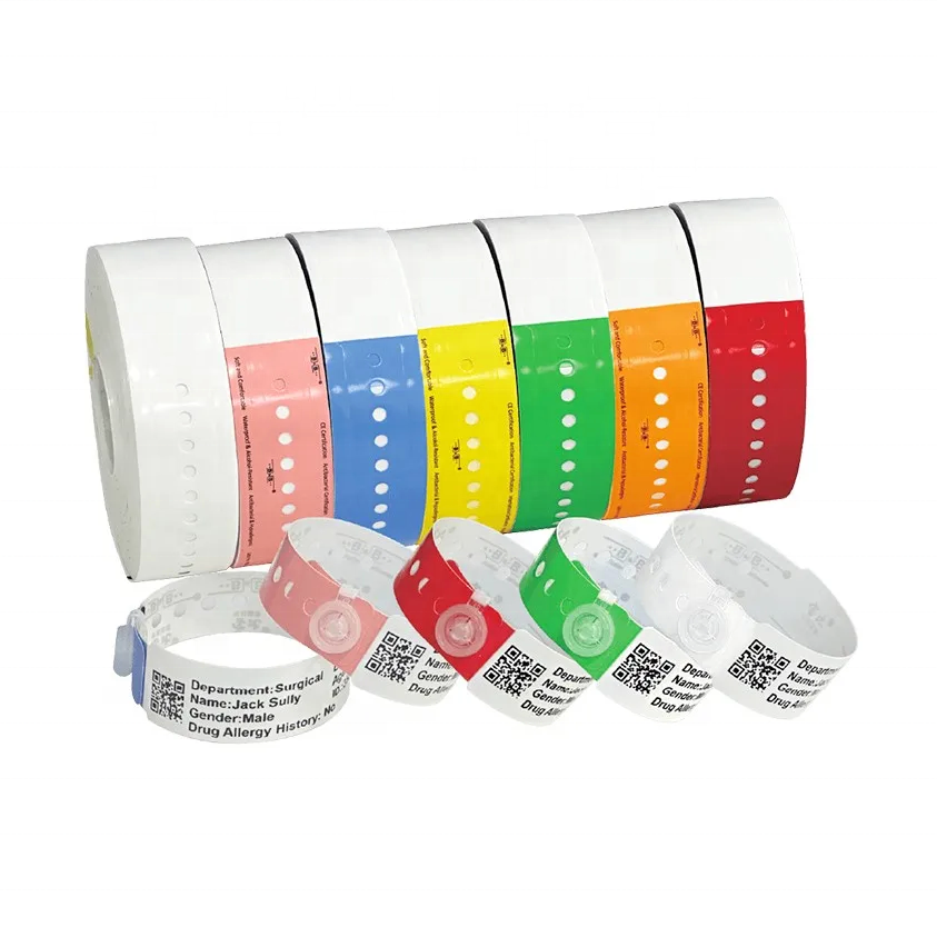 Seven rolls of color-coded thermal wristbands with printed QR codes and patient information panels