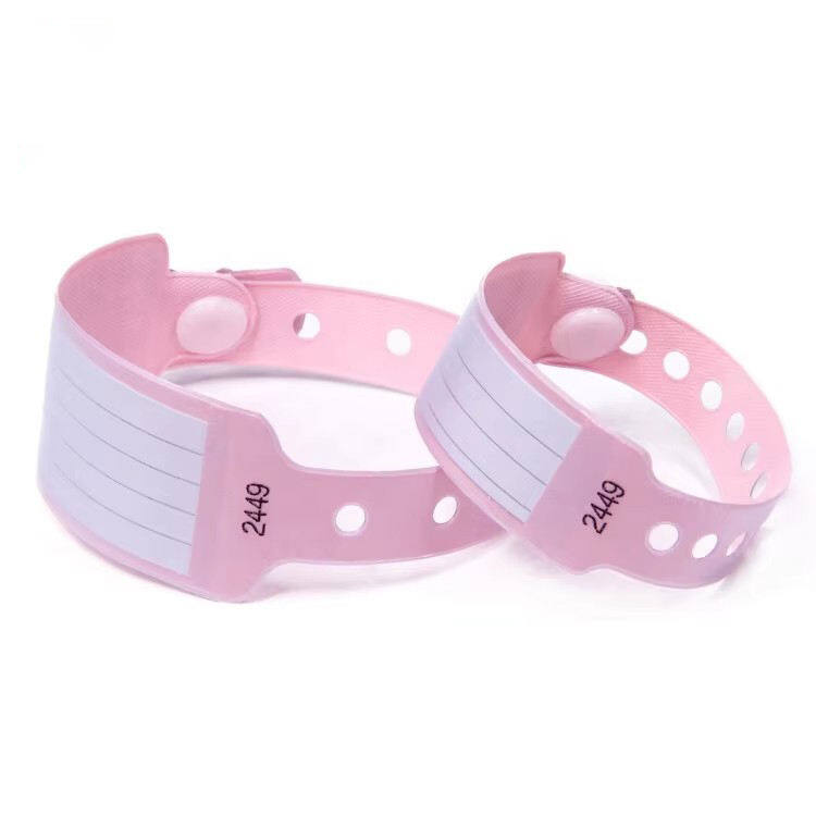Pink disposable patient wristbands with writable label area and snap lock.