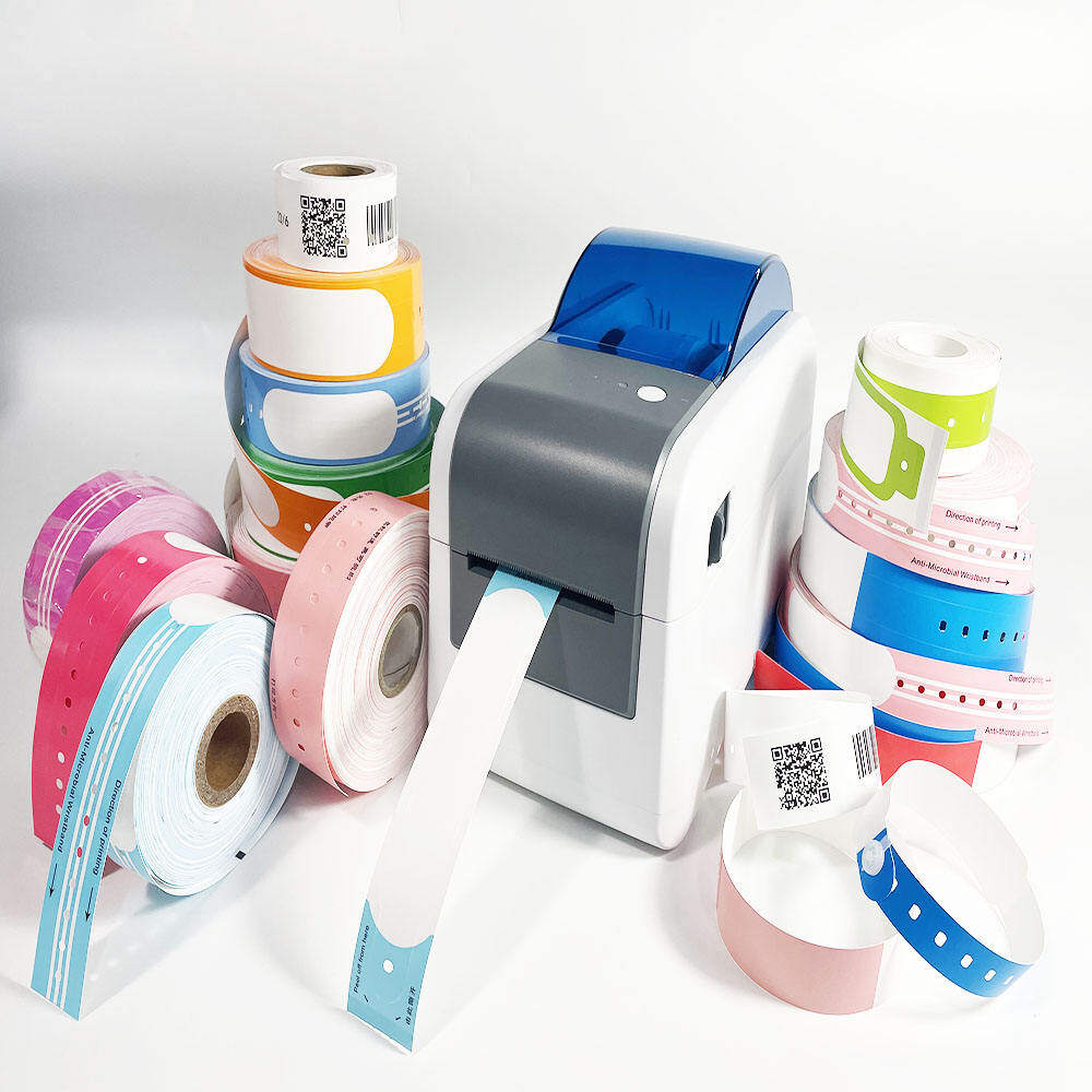 Thermal wristband printer surrounded by colorful patient identification wristband rolls with QR codes and barcodes