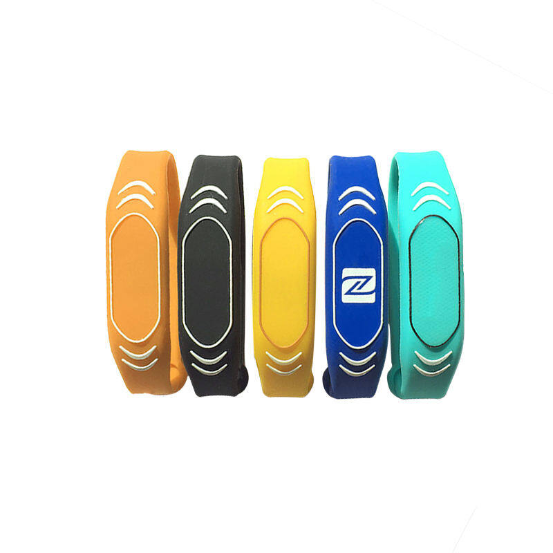 Colorful NFC silicone wristbands in orange, black, yellow, blue and teal with chip marking.