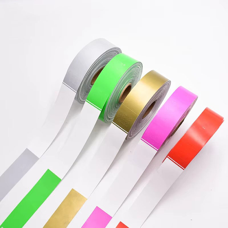 Colorful wristband rolls in white green gold pink red arranged diagonally