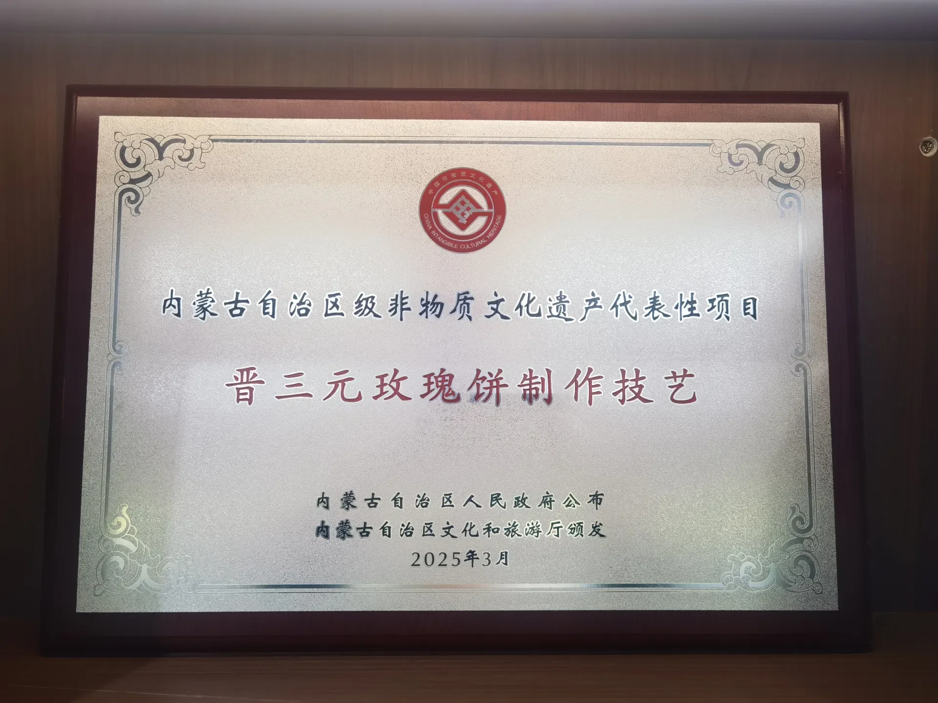 内蒙古自治区级非物质文化遗产代表性项目牌匾：晋三元玫瑰饼制作技艺，内蒙古自治区人民政府公布，内蒙古自治区文化和旅游厅颁发