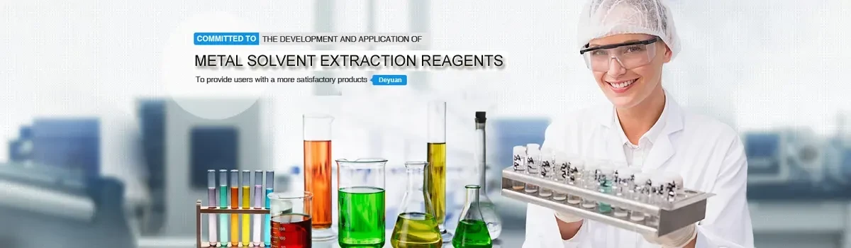 Laboratory analyst holding a rack of sample tubes beside reagent glassware