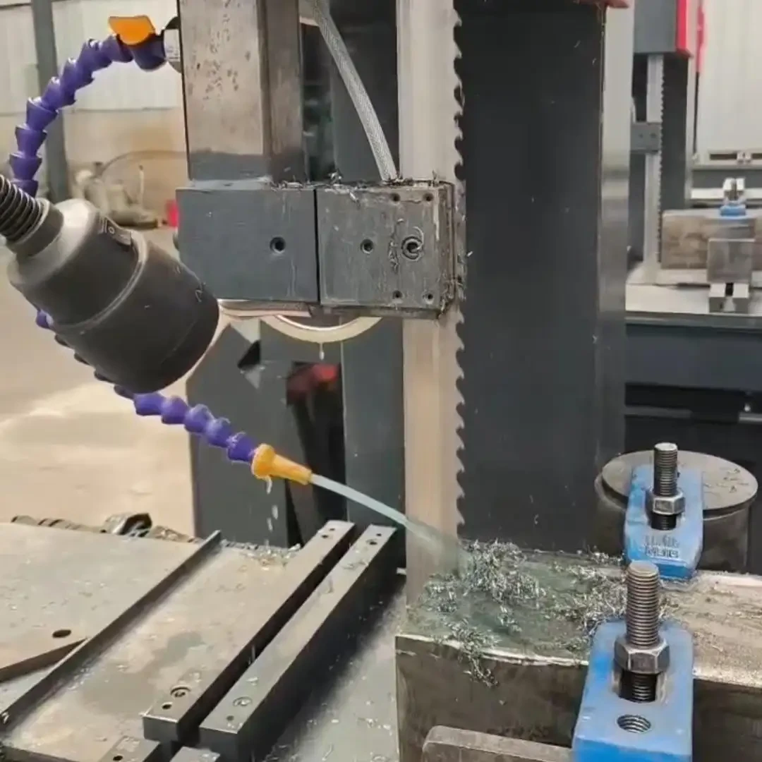 Bandsaw blade cutting a steel billet on a horizontal machine