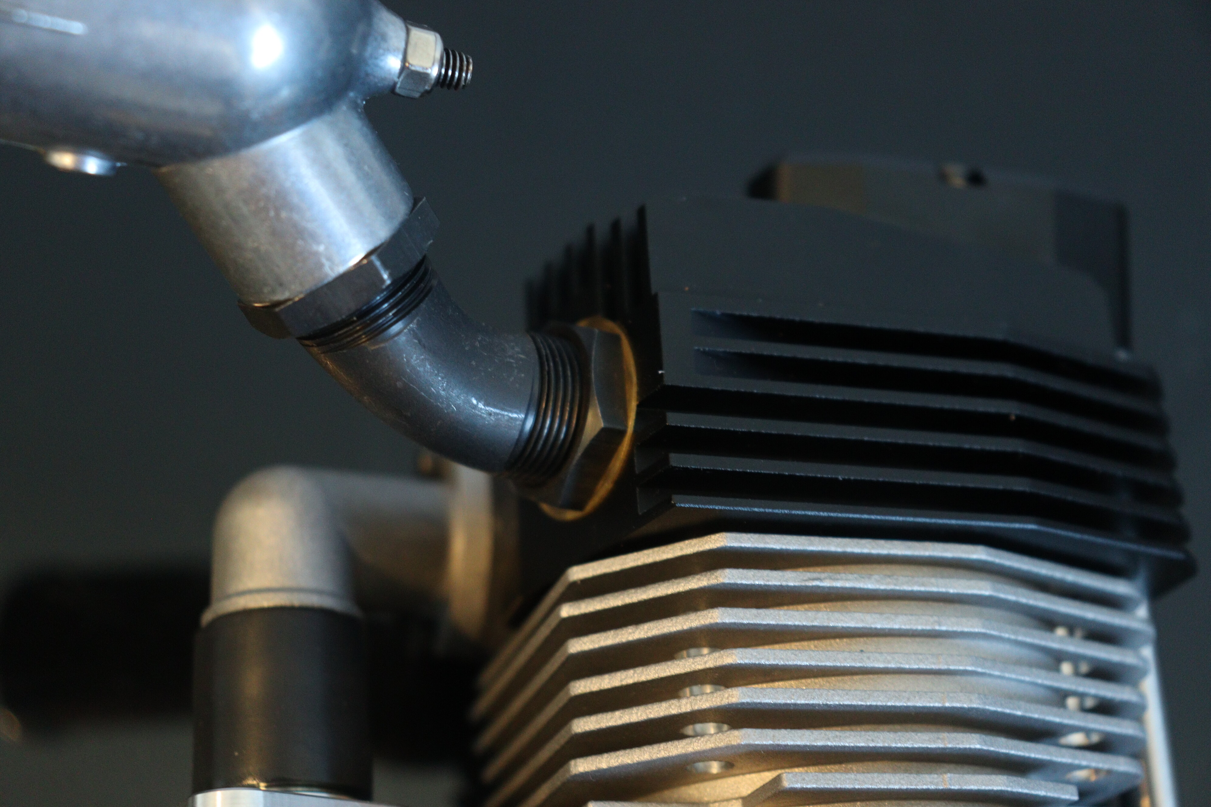 Close-up of the engine exhaust pipe and cylinder head fins