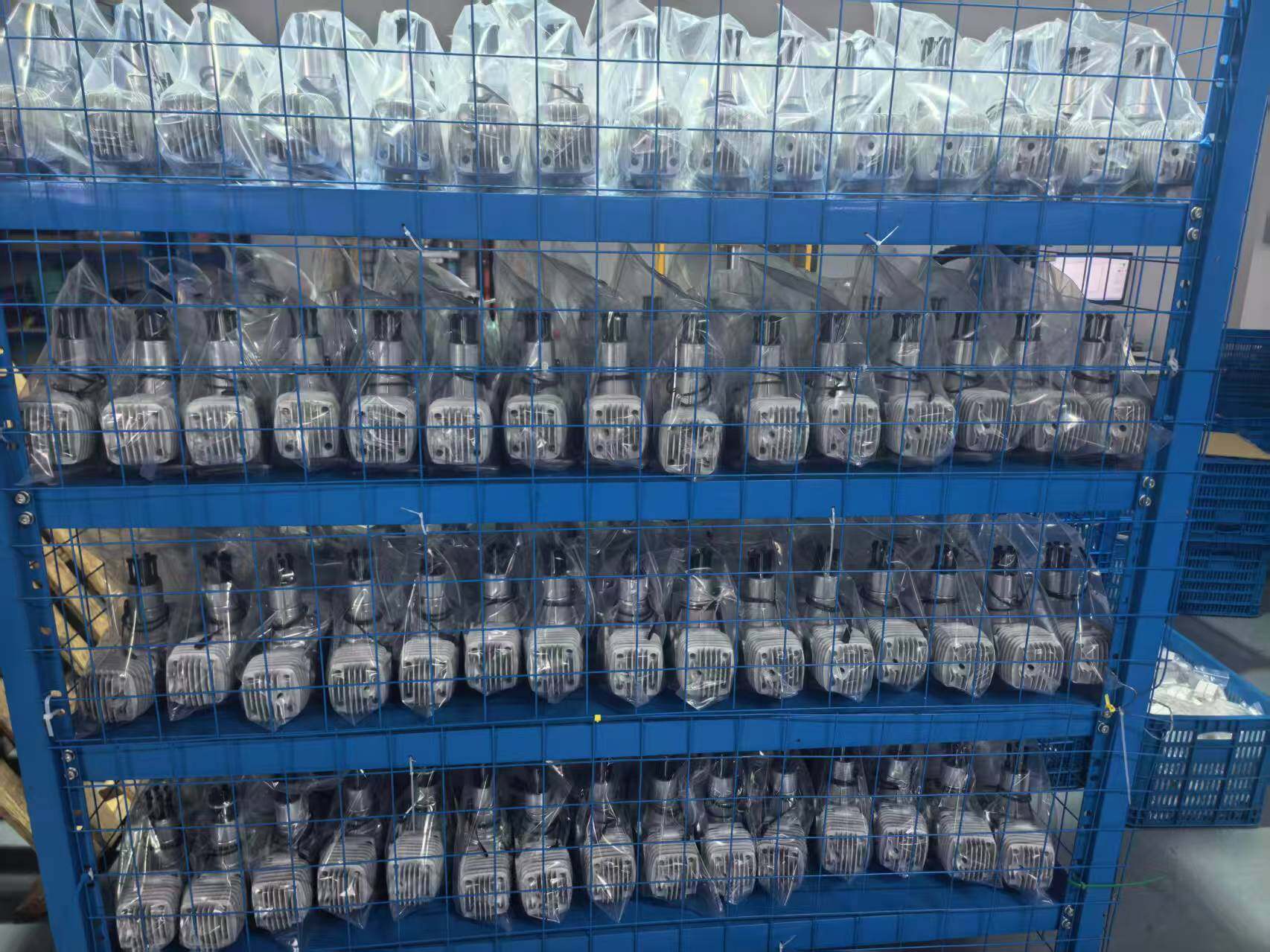 Blue metal storage cages filled with engine components